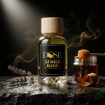 Bottle of Dose Le Male Elixir with lavender and honey on a dark surface